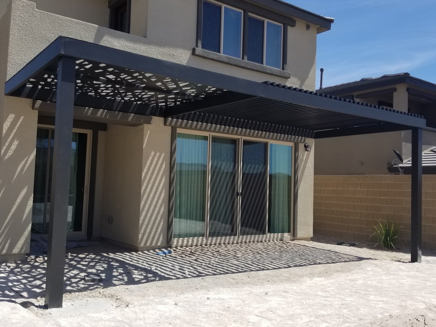 4K louvered aluminum patio cover attached to a two-story home