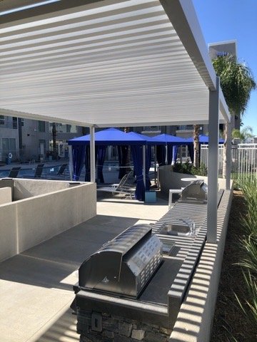 4K white louvered aluminum cover over an outdoor BBQ