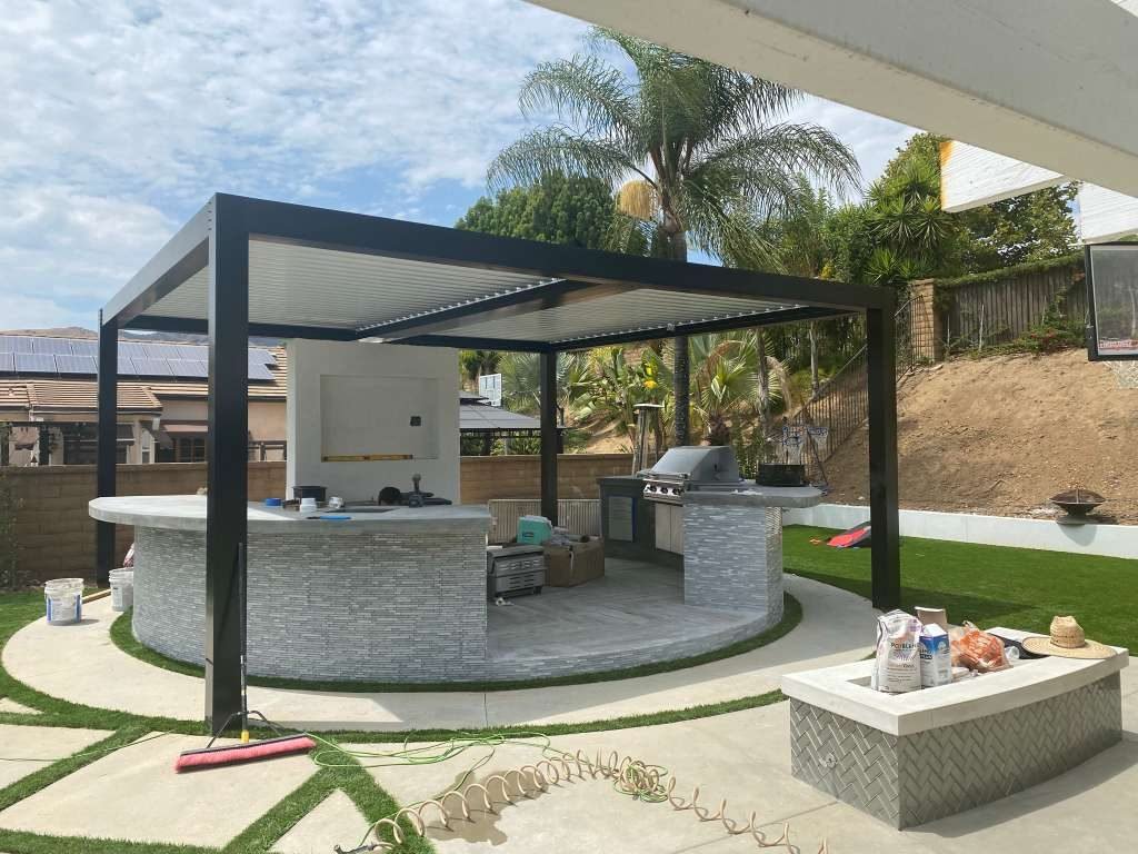 Modern black Four Seasons louvered roof attached to a white home, Los Angeles