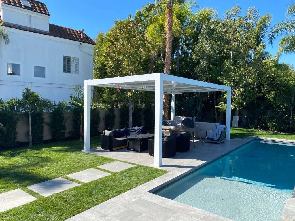 Black freestanding Four Seasons louvered patio cover over a concrete patio