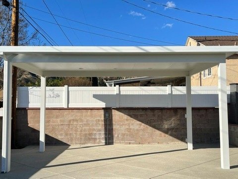 White insulated patio cover over a driveway