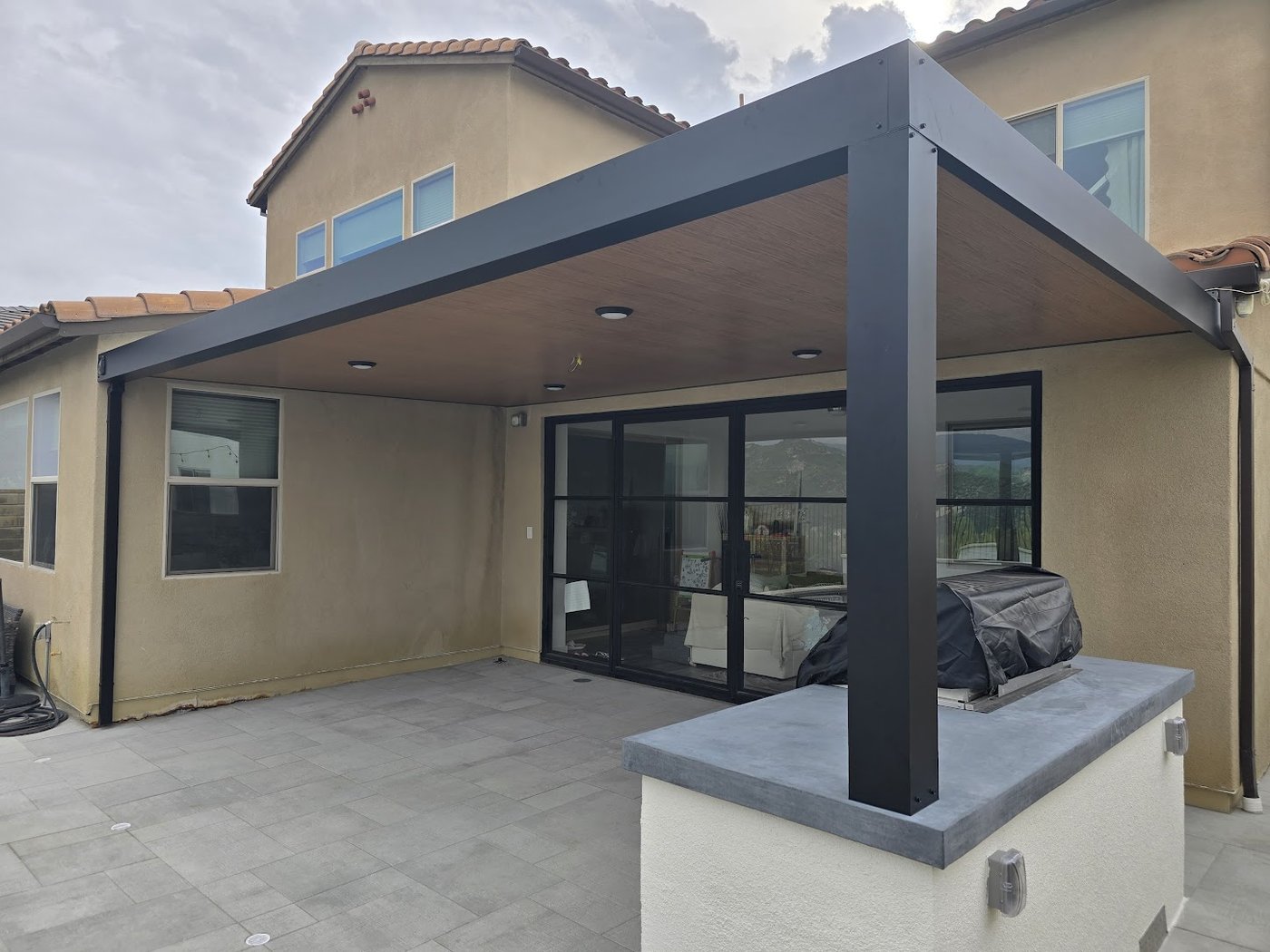 Insulated patio cover over a backyard outdoor kitchen