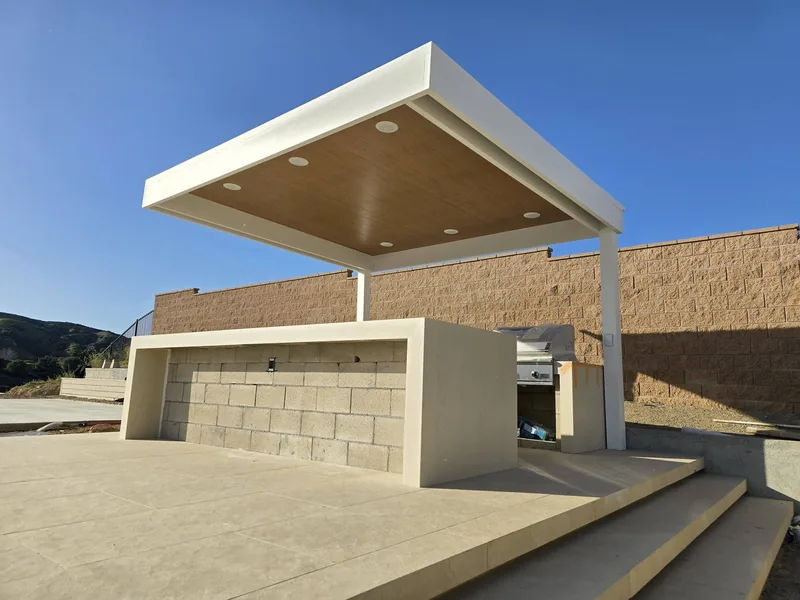 White 4K cantilever with Ponderosa Pine insulated roof panel and six recessed lights, over a barbecue area