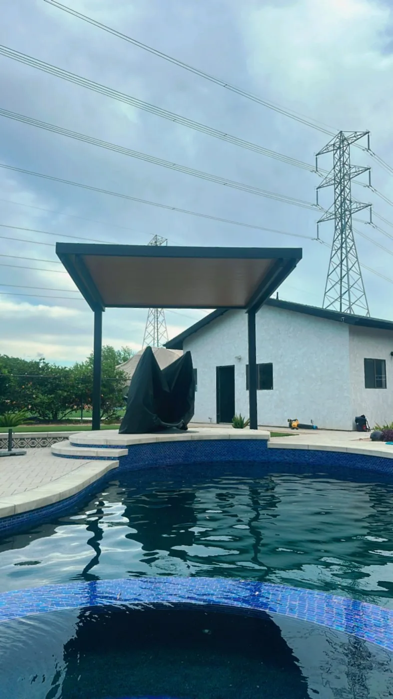 4K cantilever patio cover with espresso frame and 3-inch insulated Western Cedar roof panels, post-free on the pool side
