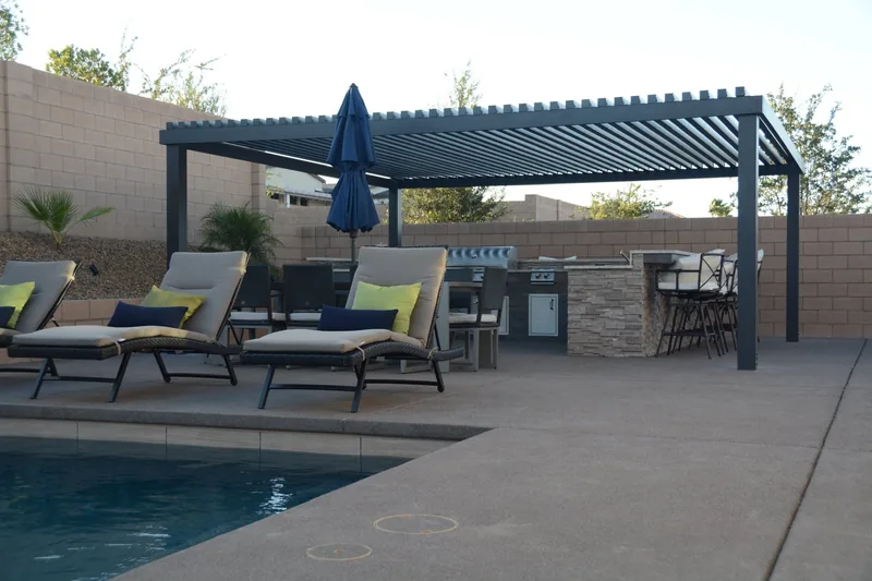 Freestanding 4K patio cover in espresso with 3-inch lattice, over a poolside barbecue area with bar seating