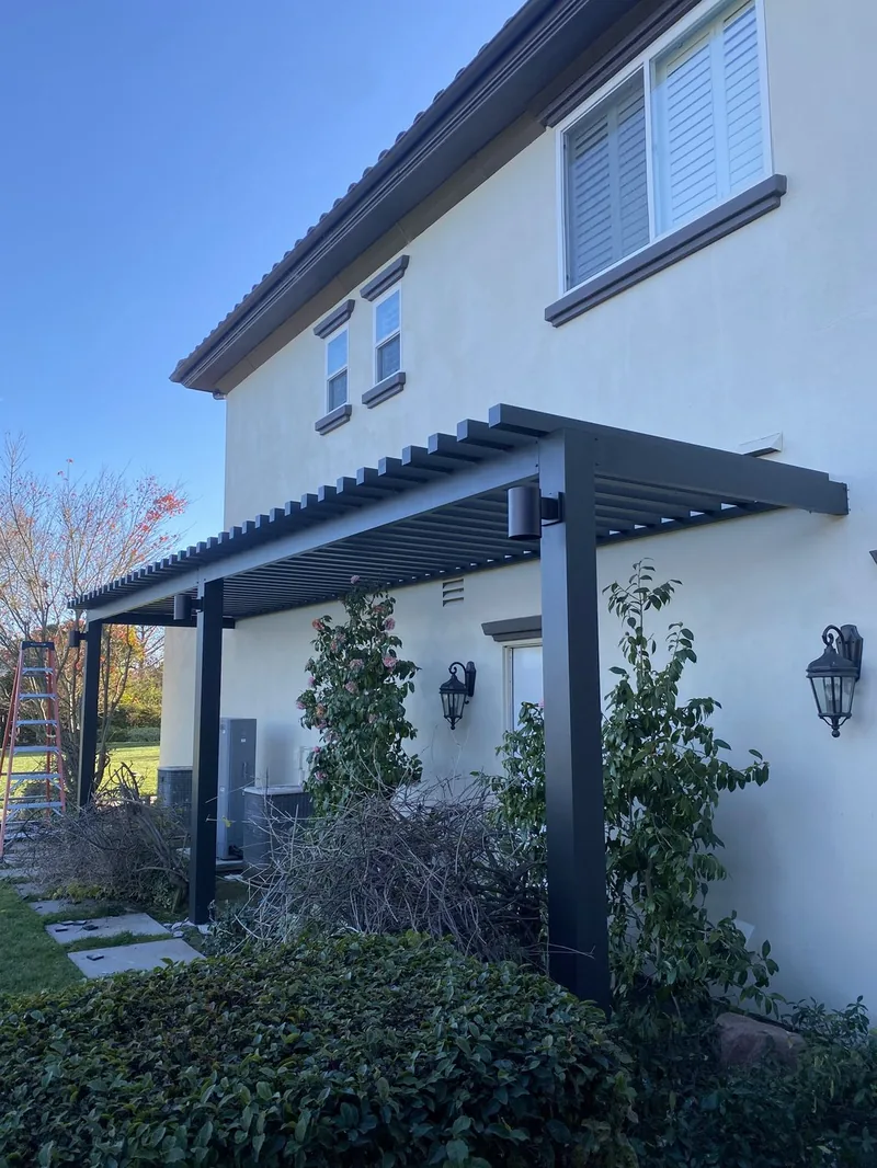 4K patio cover in espresso with 3-inch lattice, one-foot overhang and post-mounted lights, built for climbing vines